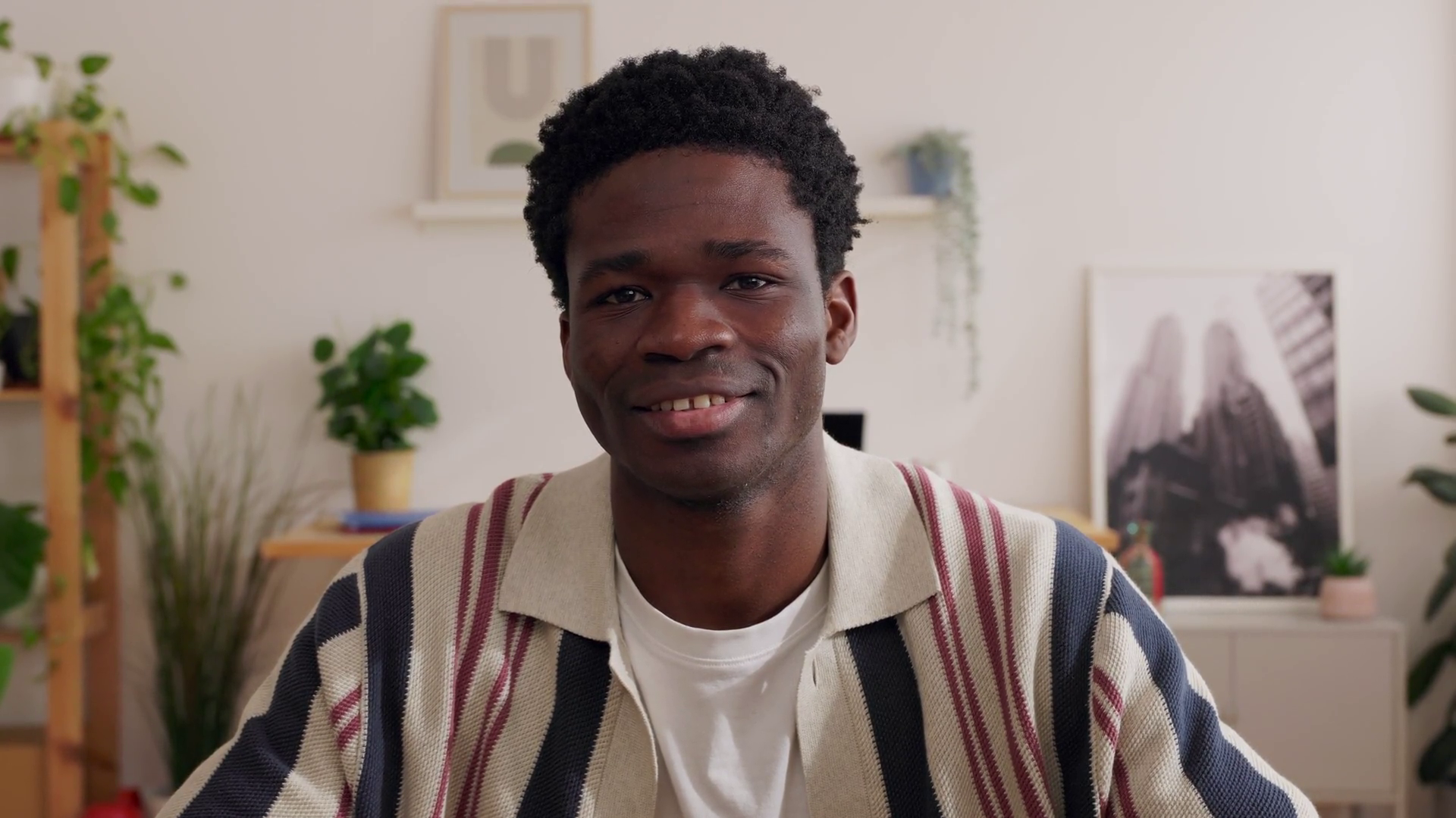 Young Black Man Smiling At Camera Sitting At Stock Footage SBV ...