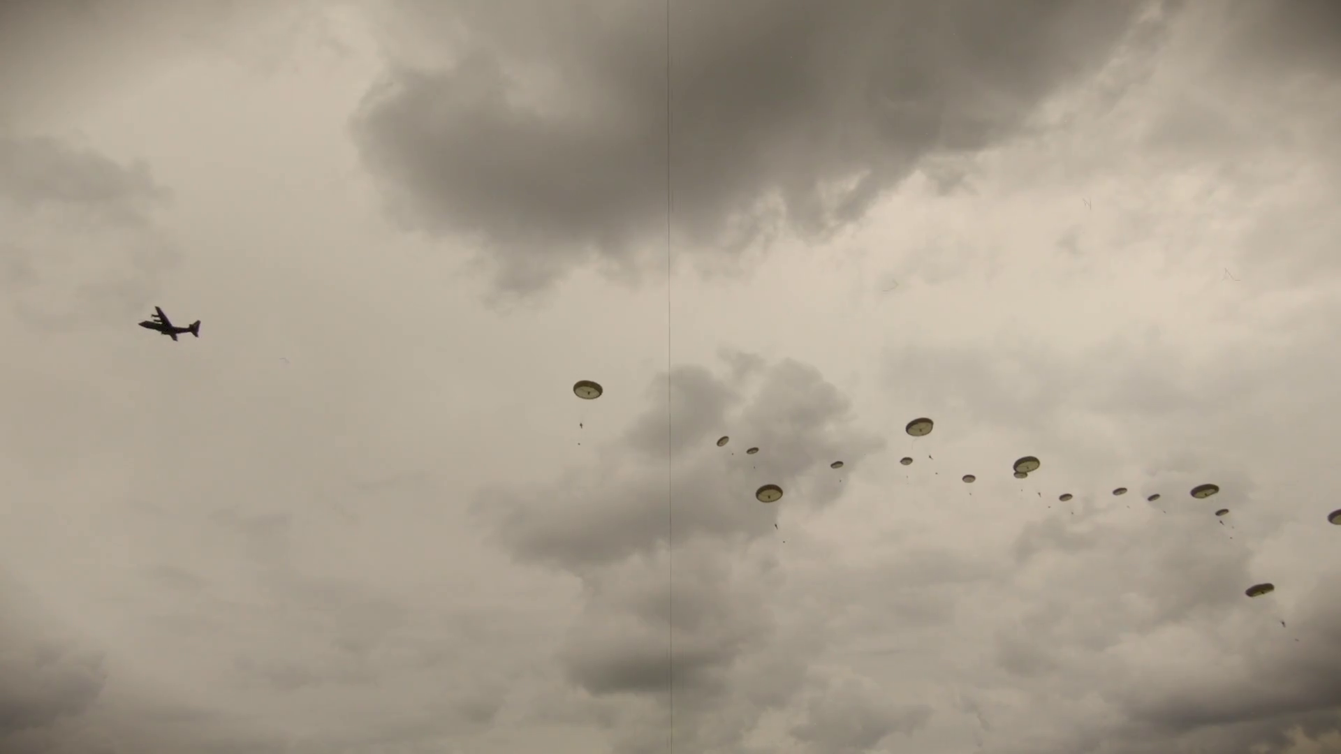 Vintage recreation of WW2 paratroopers jumping from a DC3 aircraft on D