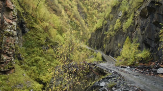 Car riding on a road to Ushguli, at the foot of Shkhara, community of villages located at the head of the Enguri gorge in Upper Svaneti, Georgia.