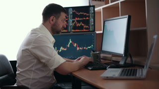 Stockbroker in white shirt is working in a monitoring room with display screens. Stock Exchange Trading Forex Finance Graphic Concept. Businessmen trading stocks online.