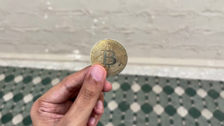 Human Hand Holding Bitcoin Coin
