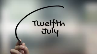 Twelfth July Handwriting With Black Marker On Glass Surface