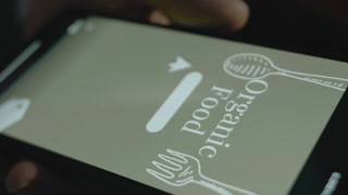 Organic food text on mobile phone screen. Creating an advertisement design on mobile app