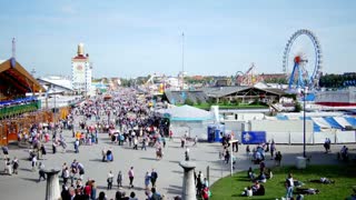 Oktoberfest celebration in munich with crowds and a ferris wheel in the background
