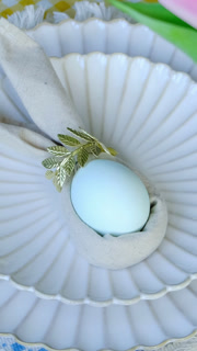 Vertical video. Easter table setting. Plate with decorated Easter egg. Festive dinner.