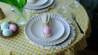 Easter table setting with tulips and Easter eggs. Spring table decoration. Holiday dinner.
