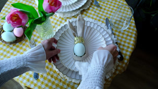 Woman setting table for Easter