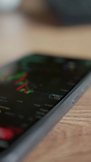 Financial chart on smartphone screen with price marker
