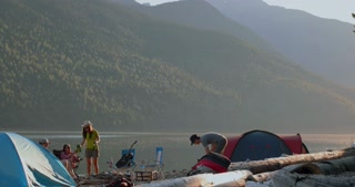 Group of friends camping near riverside 4k