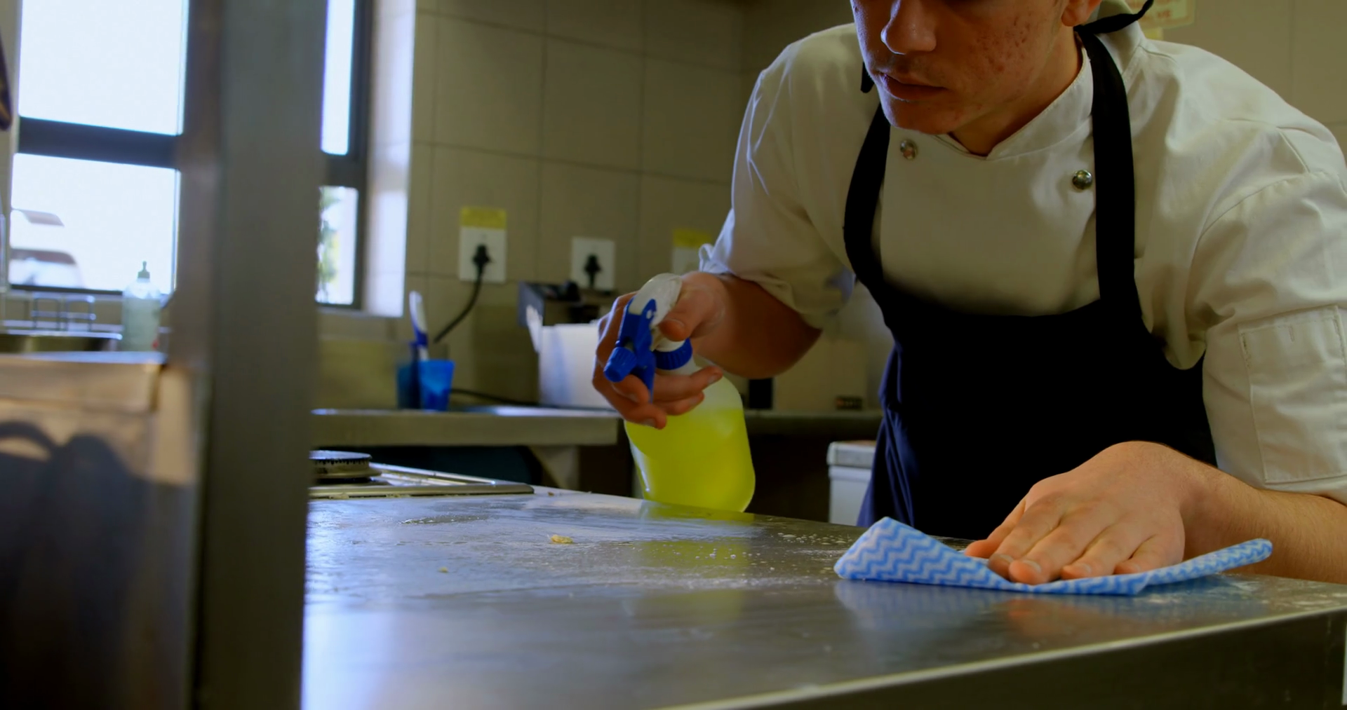 Male chef cleaning worktop in kitchen 4k Stock Video Footage 0012 SBV