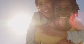 Man giving piggyback ride to woman on the beach 4k