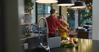 Happy couple dancing in the kitchen