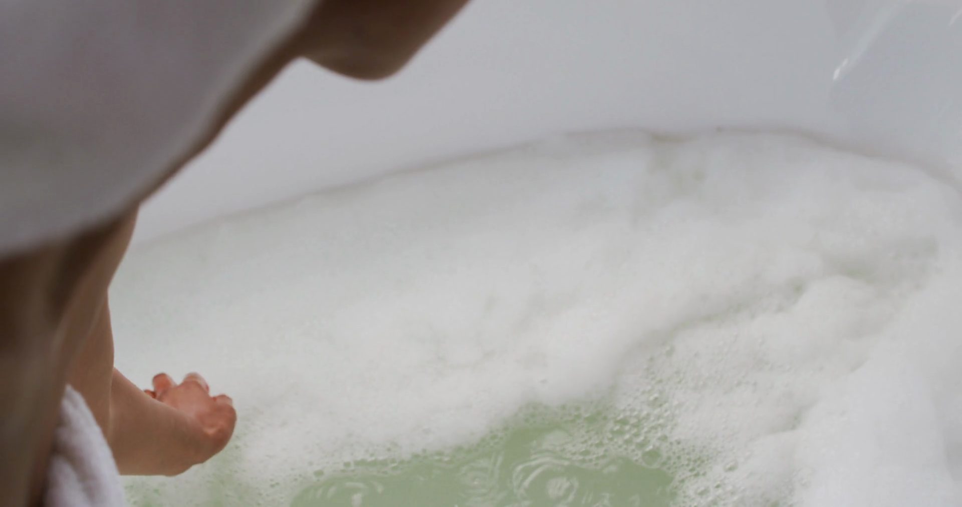 African american woman touching water in the bath tub in the bathroom