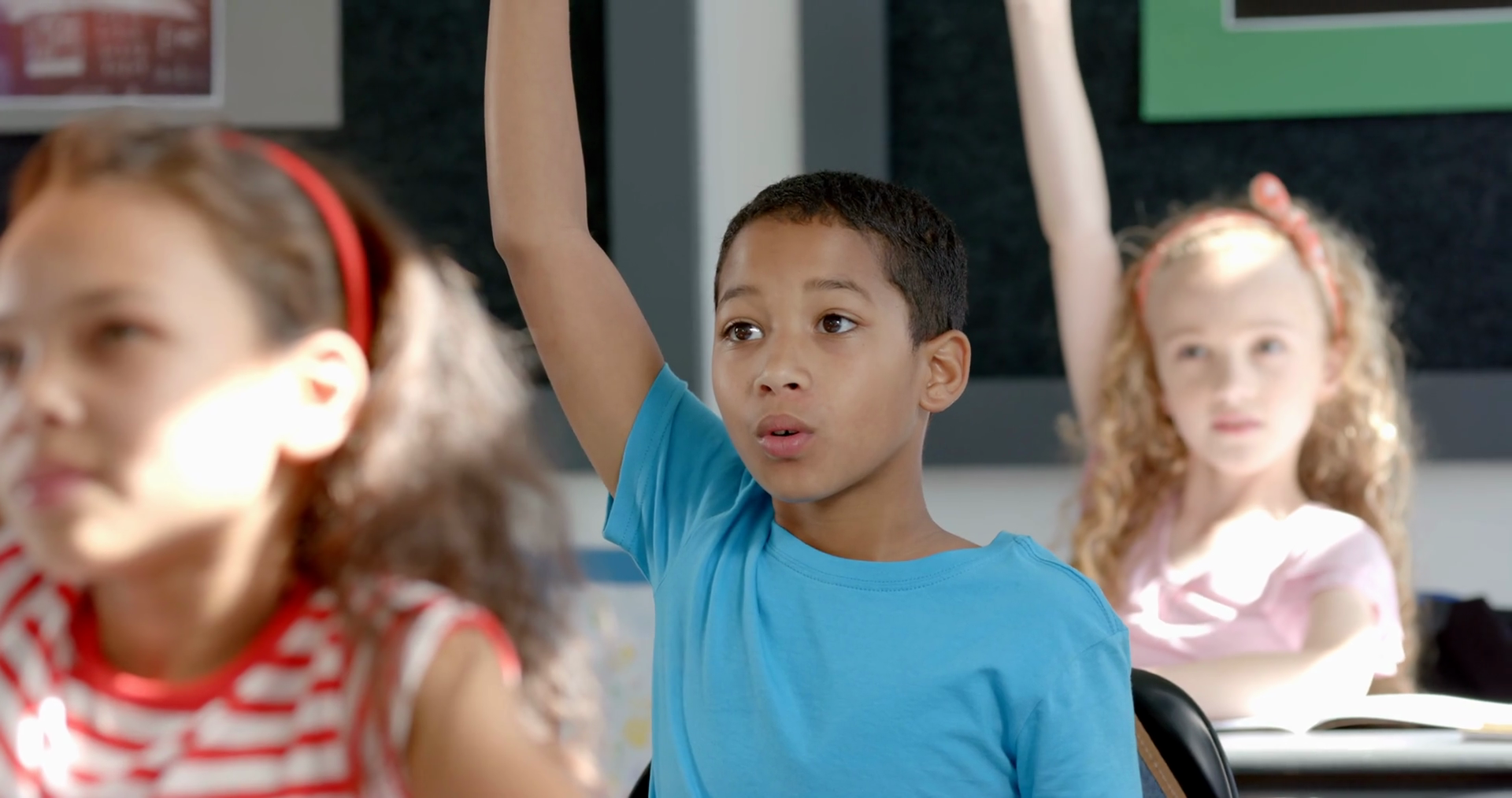 Boy Raises Hand Eagerly In Classroom Setting Stock Footage SBV ...