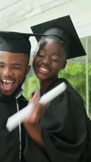Vertical video: Cap placing African American classmates getting diploma, taking selfie on campus
