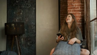 Woman Using Mobile Phone. Woman Laughing Happily. Slow Motion.