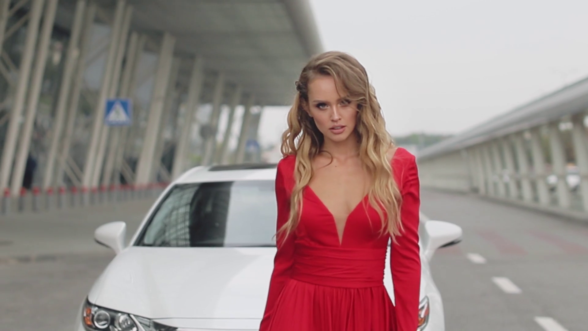 Fashion Model In Red Dress And High Heel Shoes Is Walking On Street