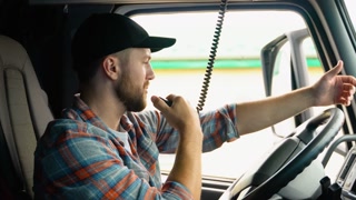 Truck Driver Making Talking Through Radio. Semi Truck