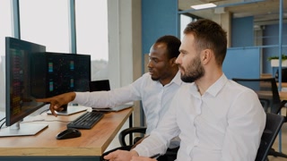 Team of stockbrokers are having a conversation in office with display screens. data, graphs and reports for investment purposes