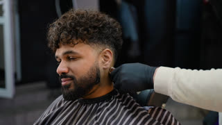 Professional barber giving a haircut to Arab client