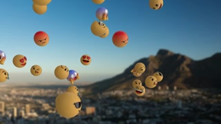 Emoji icons flying over landscape