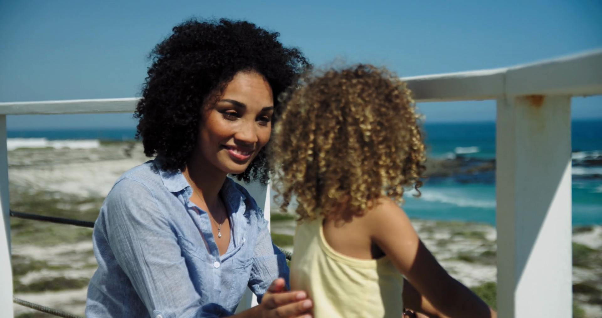 MS Mother and daughter (45) talking on balcony, Claremont, Cape Town