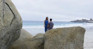WS Couple kissing on boulders on beach, Cape Town, South Africa