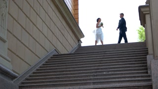 Bride and groom near stairs. Wedding couple kissing and hugging. Step towards love and happiness. We are a family now.