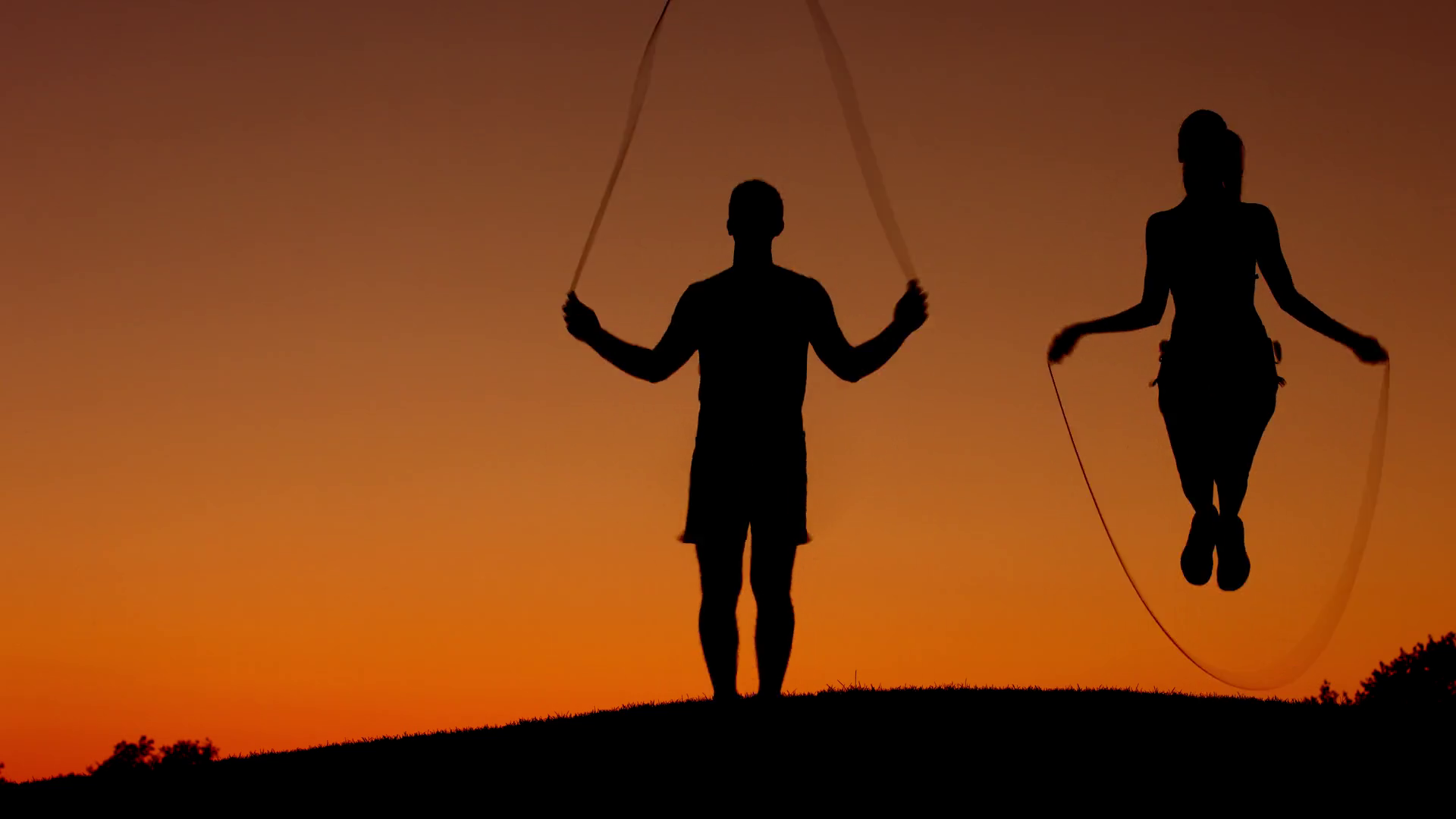 Guy With Girl Warming Up On Skipping Rope Stock Footage SBV311783230