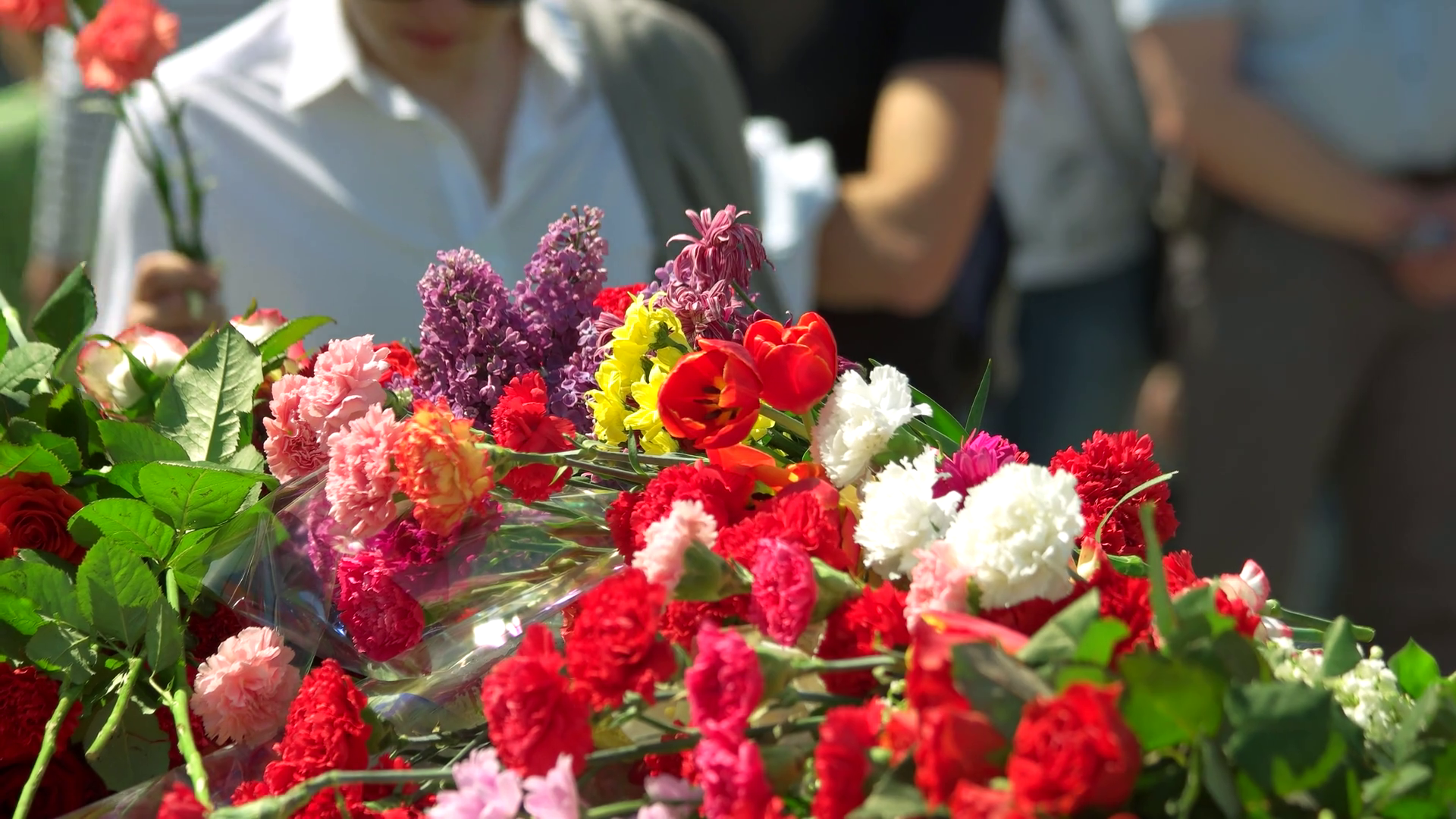 Big pile of flower bouquets. People put flowers in memory of world war