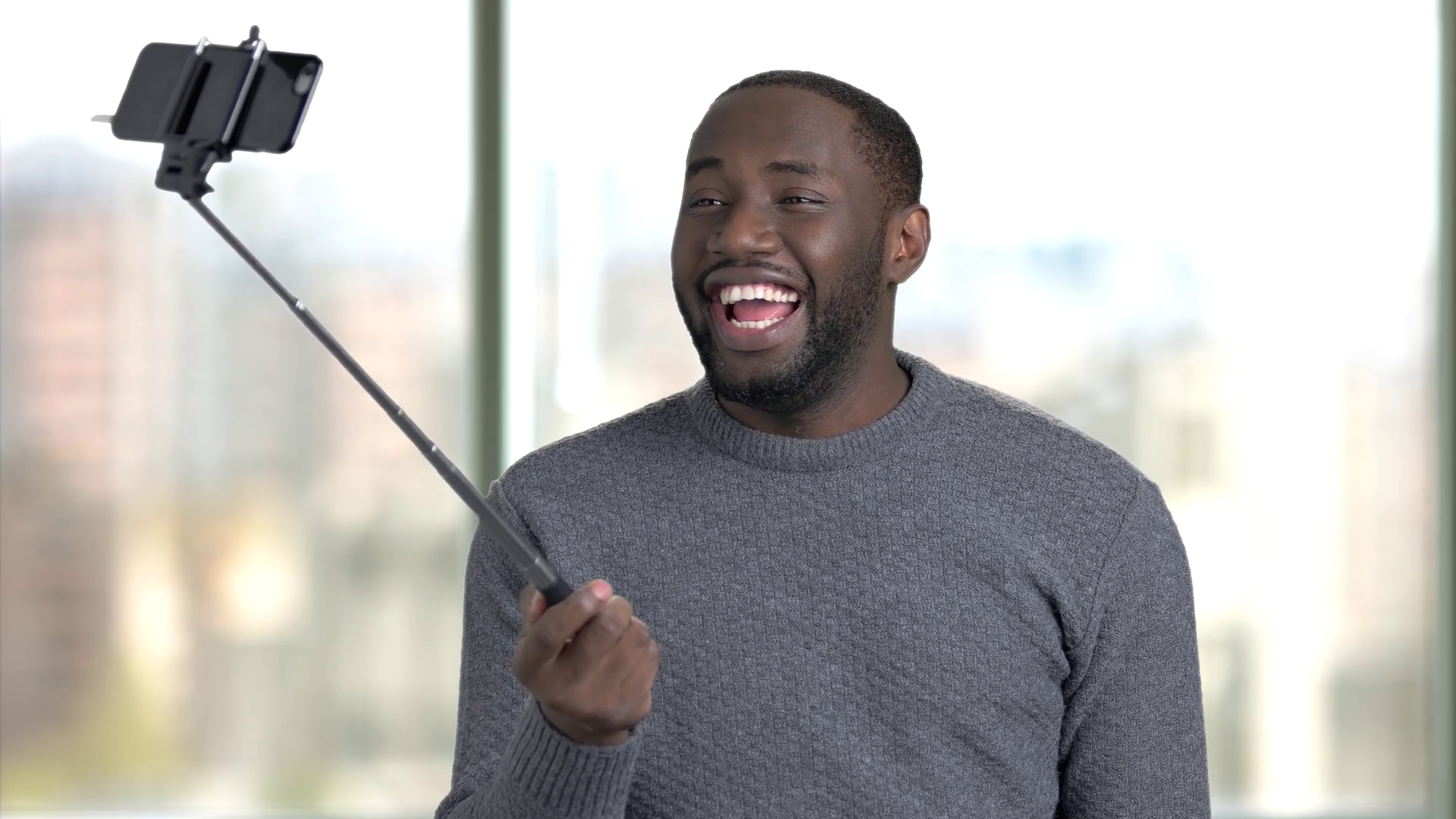 Black african man taking selfie using selfie stick. African American