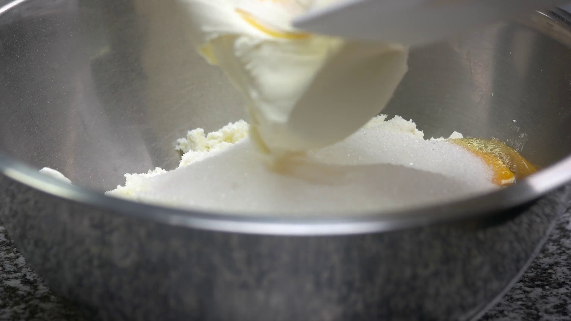 Butter cream ingredient. Adding two butter cream pieces to bowl, close