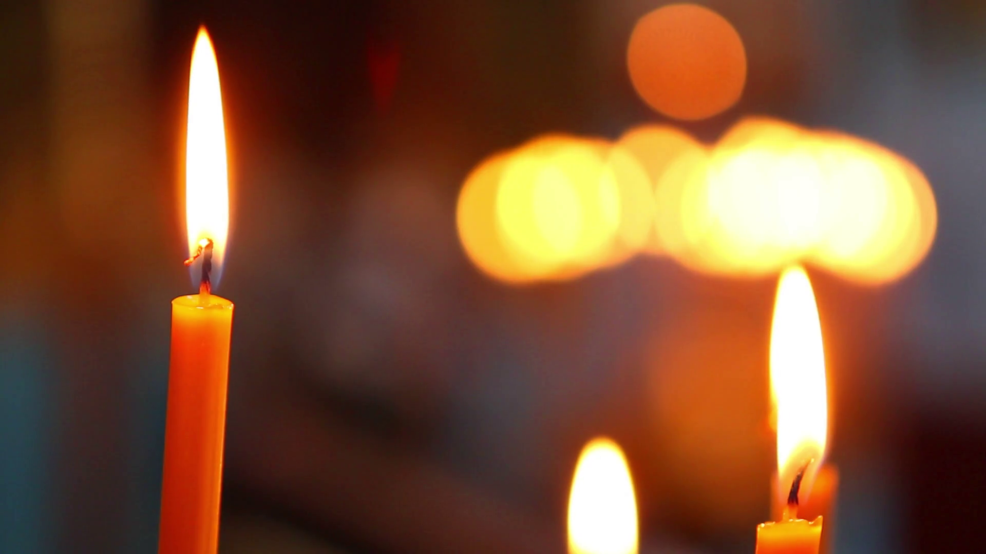 Candles are lit in the temple. Candles illuminate the church. Magic