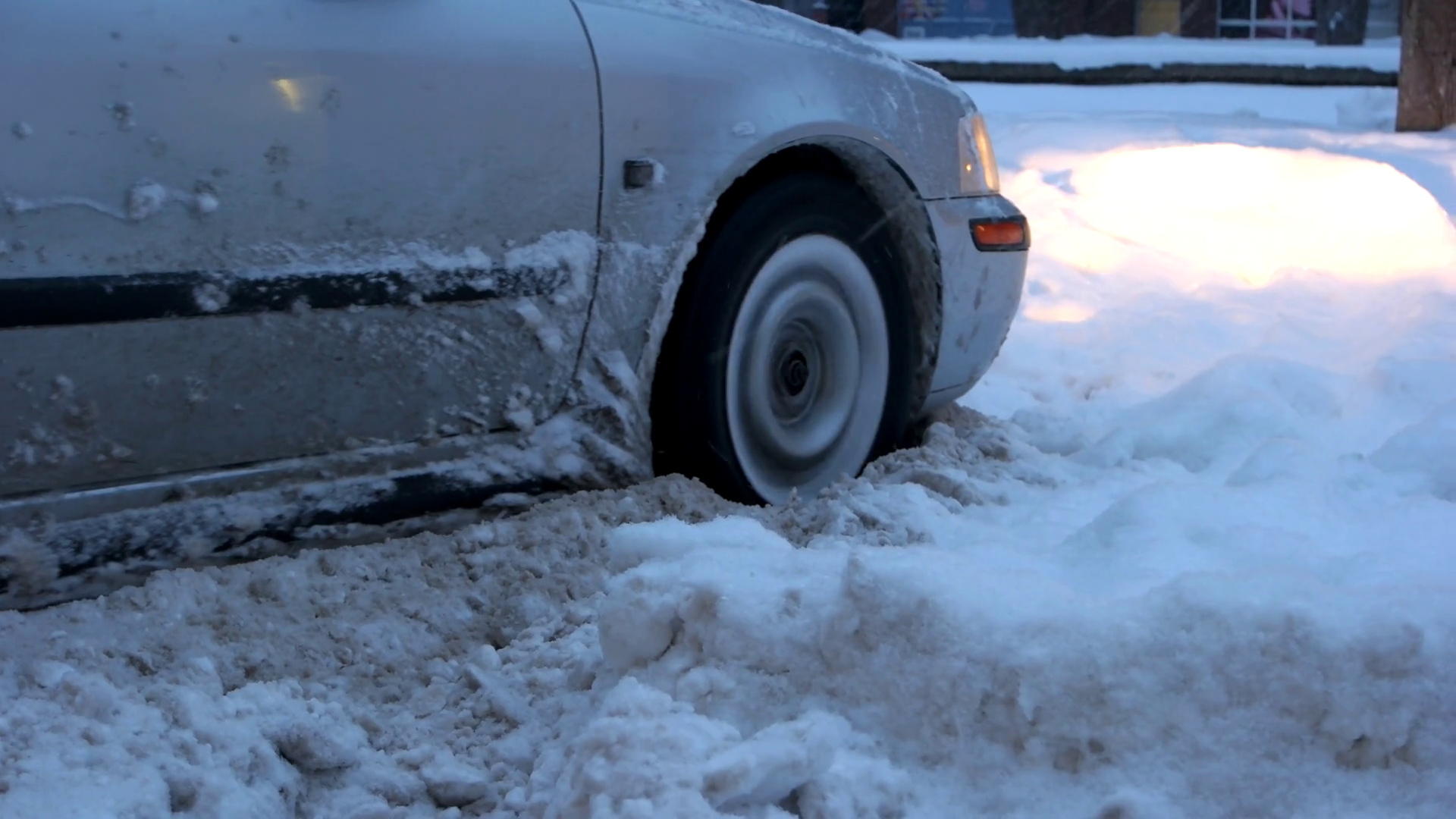 Car stalled in the snow. Close up of car wheel stuck in snow drift. Did