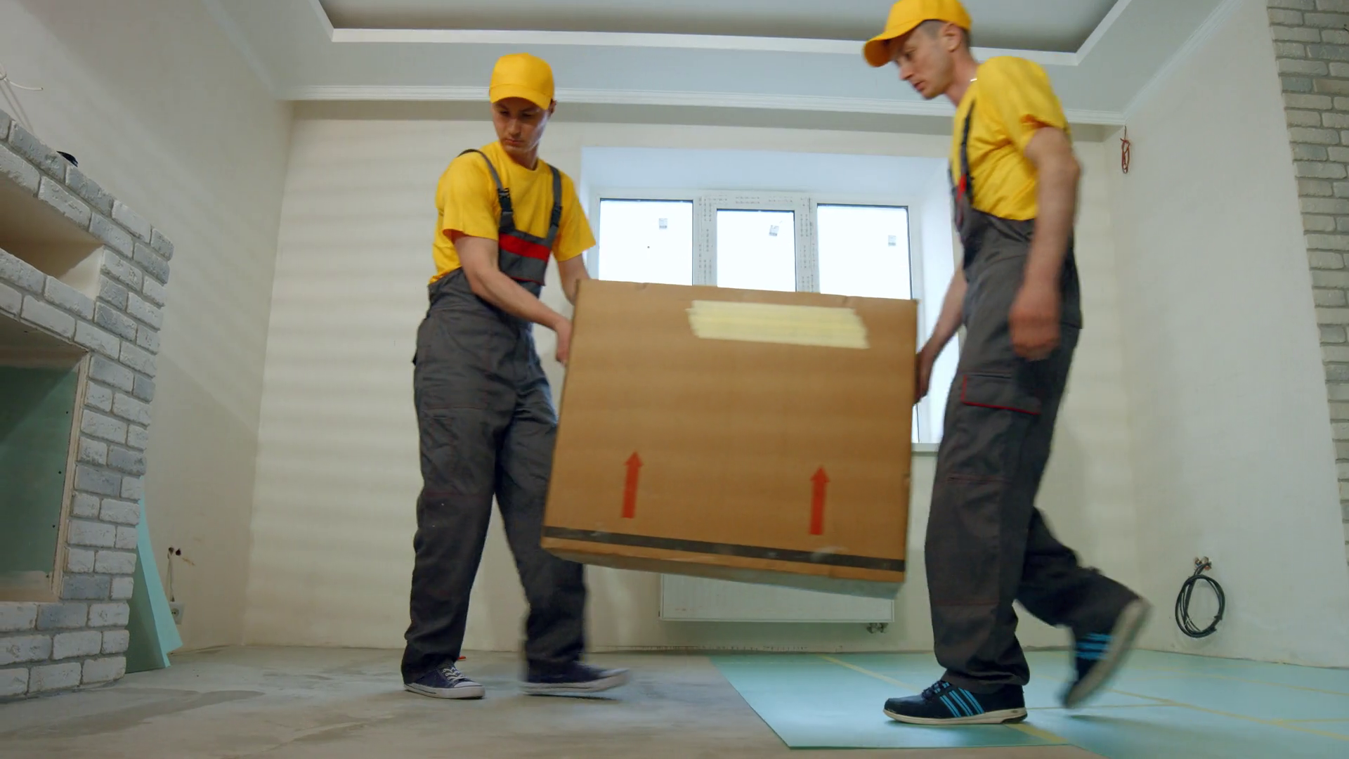 Courier delivery service. Loaders deliver household appliances. Stock