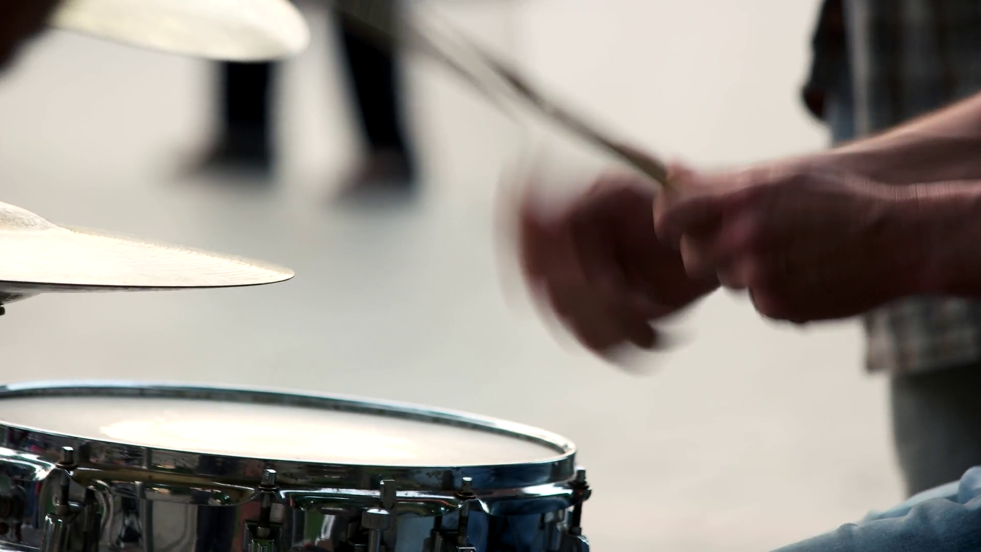 Hands of the musician with a drumstick. Close up. Male hands playing