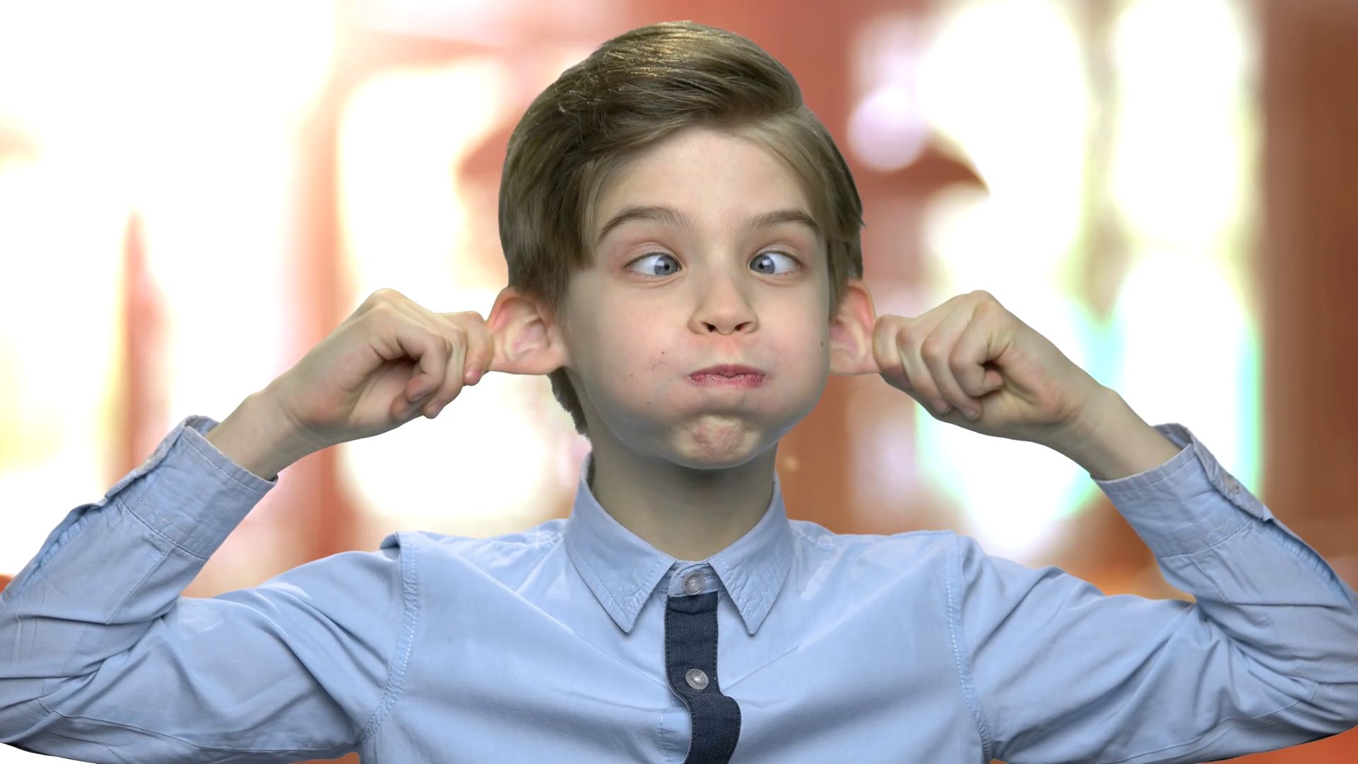 Little caucasian boy making monkey face. Cute child fooling around. Kid