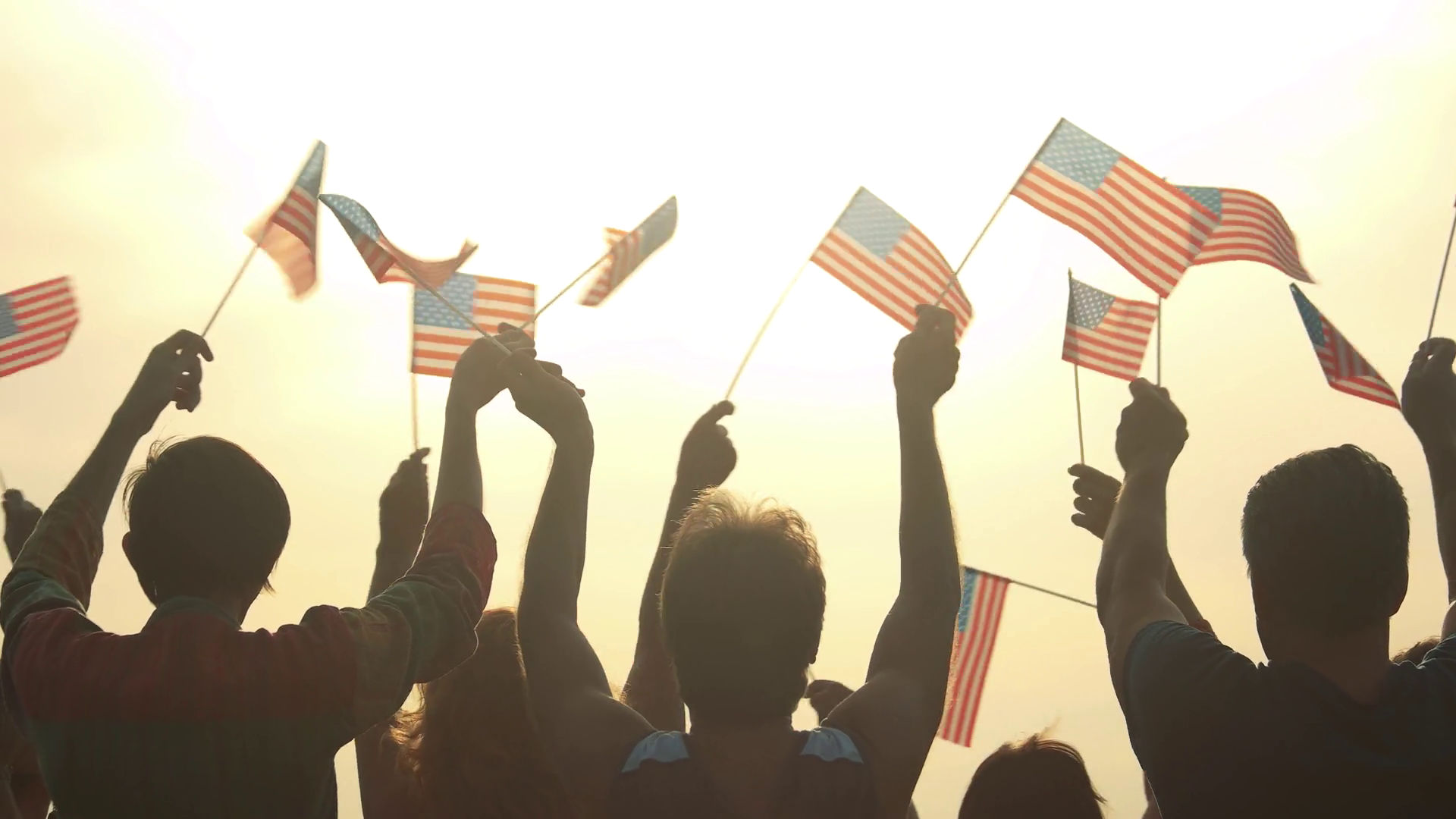 People with American flags at morning sky background. Patriots