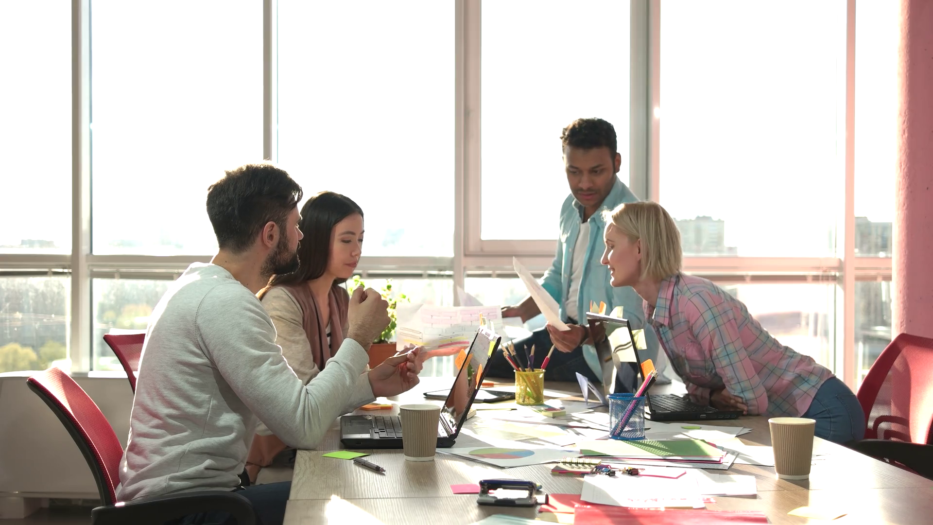 Teamwork concept cheerful coworkers taking papers. Office work papers