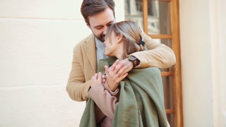Positive couple kissing outdoors