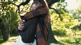 Pleased young couple hugging in sunny park