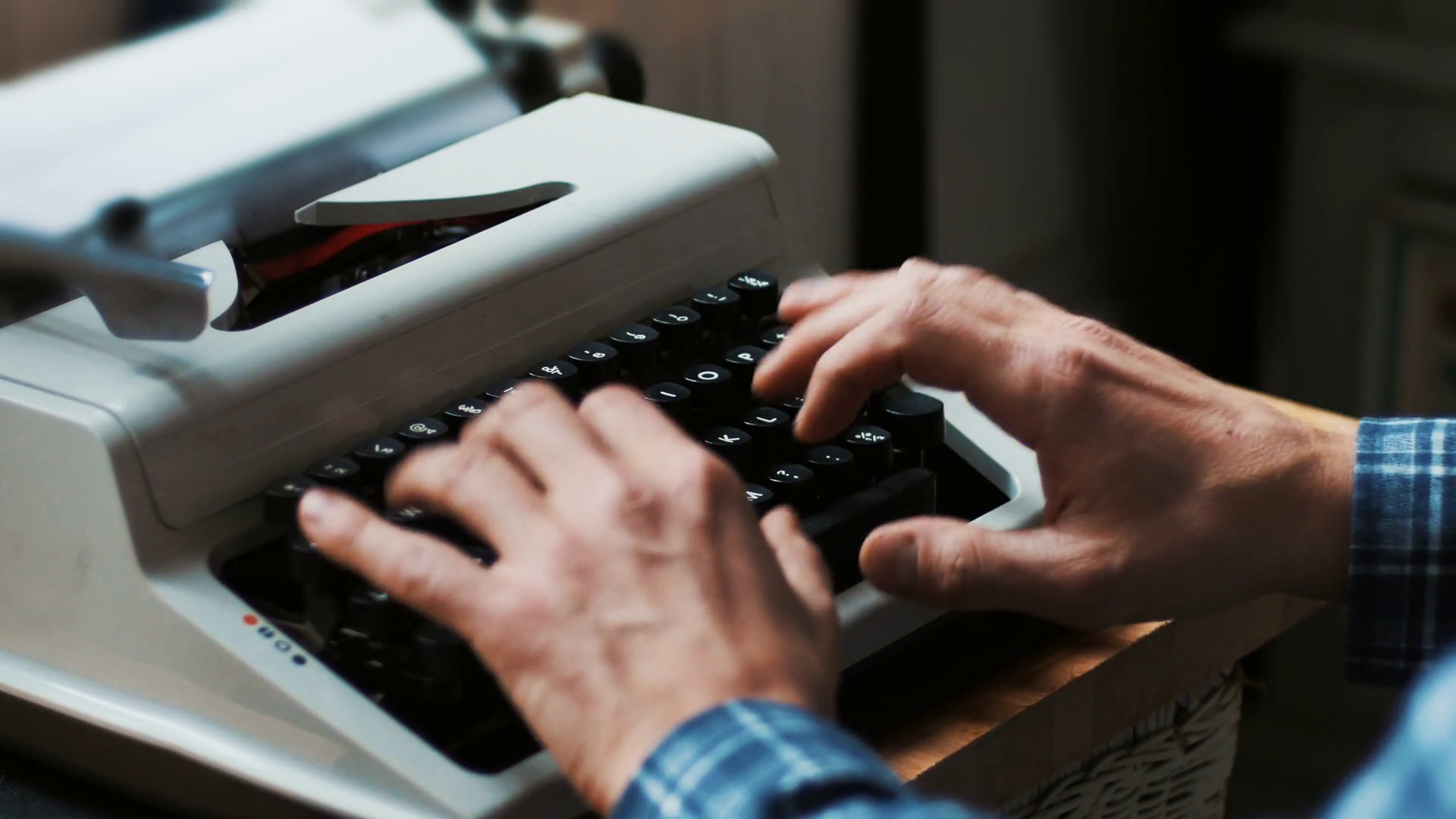 Typing on a vintage typewriter machine. Writing a love letter by the
