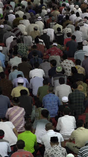 JAKARTA, INDONESIA  APRIL 2017: Vertical view of people waiting for Friday prayer in the Istiqlal mosque in Jakarta, religion and culture in Indonesia