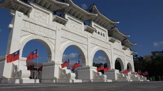 TAIPEI, TAIWAN  14 OCTOBER 2015: Taiwanese flags wave at the entrance gate of Chiang Kai-shek memorial hall in Taipei, Taiwan