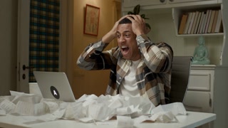 Man exhausted with budget. African American man screaming because of huge expenses. Lots of receipts on the table.