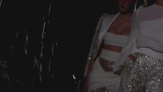 Models walking catwalk during fashion show event