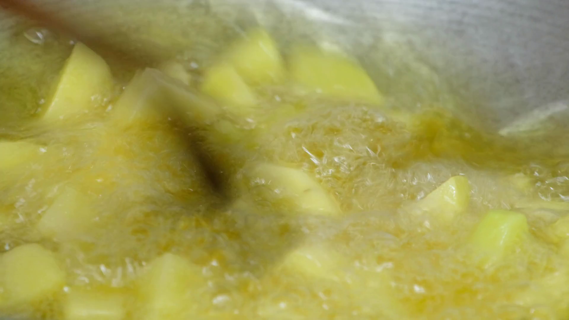 Deep frying cut potato cubes with cooking oil in a hot pan. Stock Video