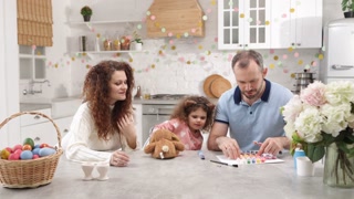 Portrait of a charming, young family preparing for Easter holiday