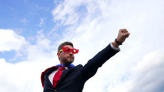successful man in hero mask on sky background, leader aspirations