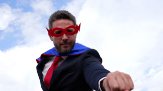 business success concept with man in super hero mask, slow motion, achievement